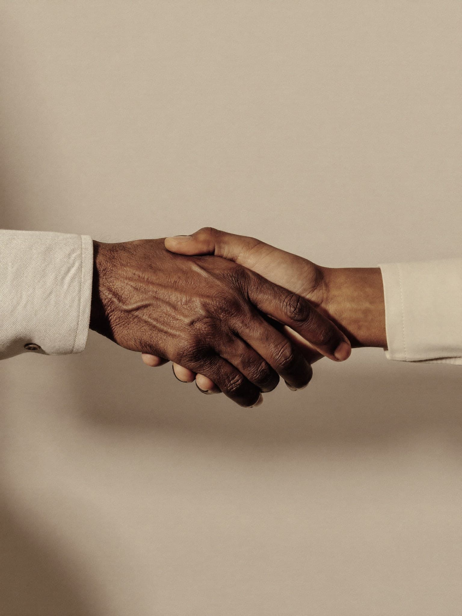 Two hands meeting in a warm handshake